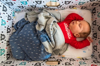caption: The moms of newborn Finnish babies are given government-issued baby boxes—stocked with clothes, bedding and toys — and also doubling as a makeshift crib. The group Finnwatch wanted to know who manufactured the goods.