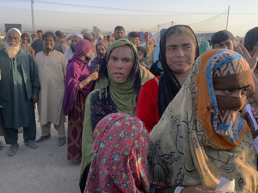 caption: Afghan families gather after leaving their homeland and reaching the Pakistan side of the border, near the town of Chaman on Tuesday. Pakistan and other countries bordering Afghanistan have mostly closed their borders to Afghan refugees, with some exceptions.