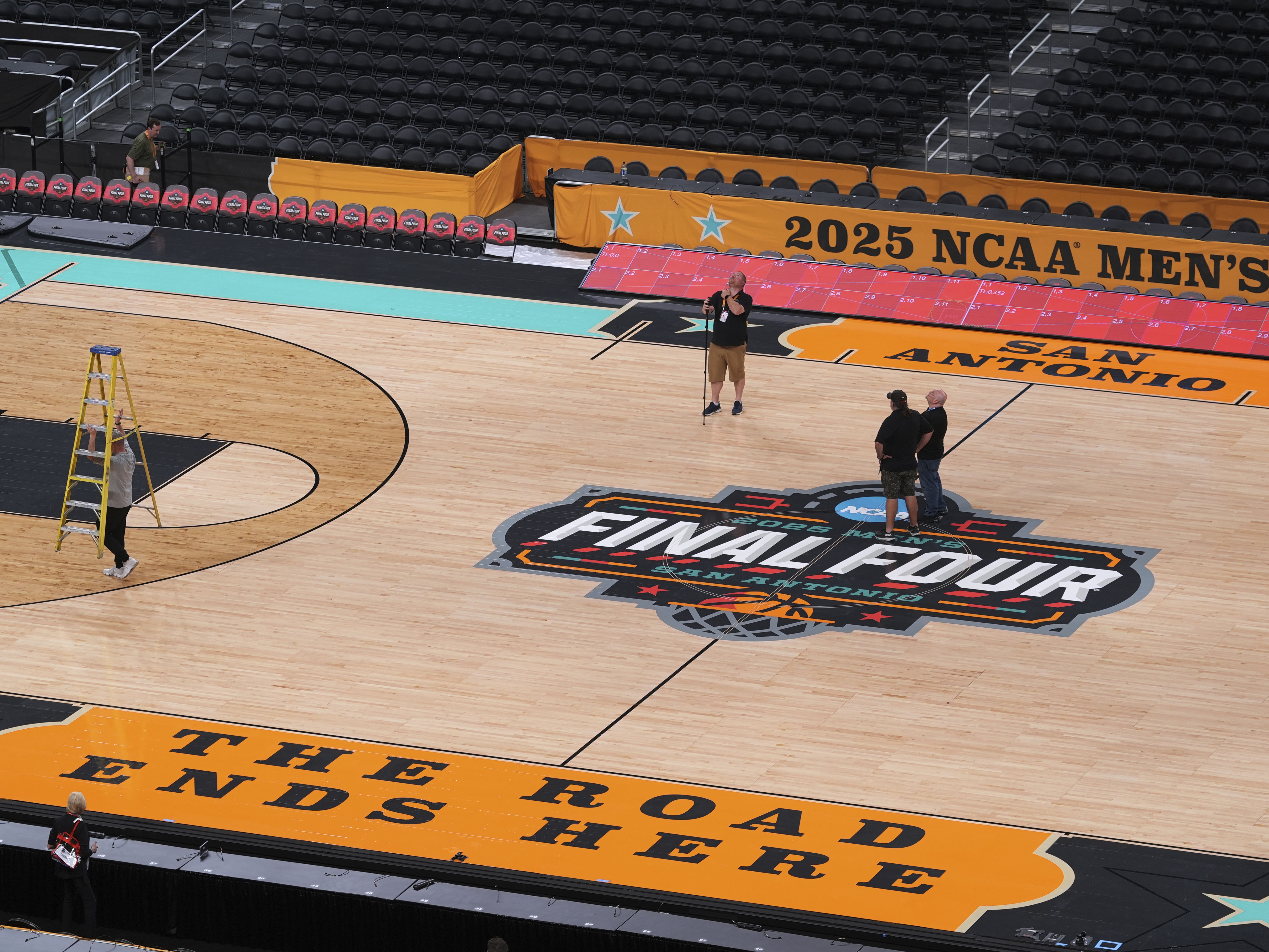 caption: Workers make final preparations around the Men's NCAA Final Four college basketball court at the Alamodome, Monday in San Antonio. The men tip-off on Saturday. The Women's Final Four tournament, played in Atlanta, begins on Friday.