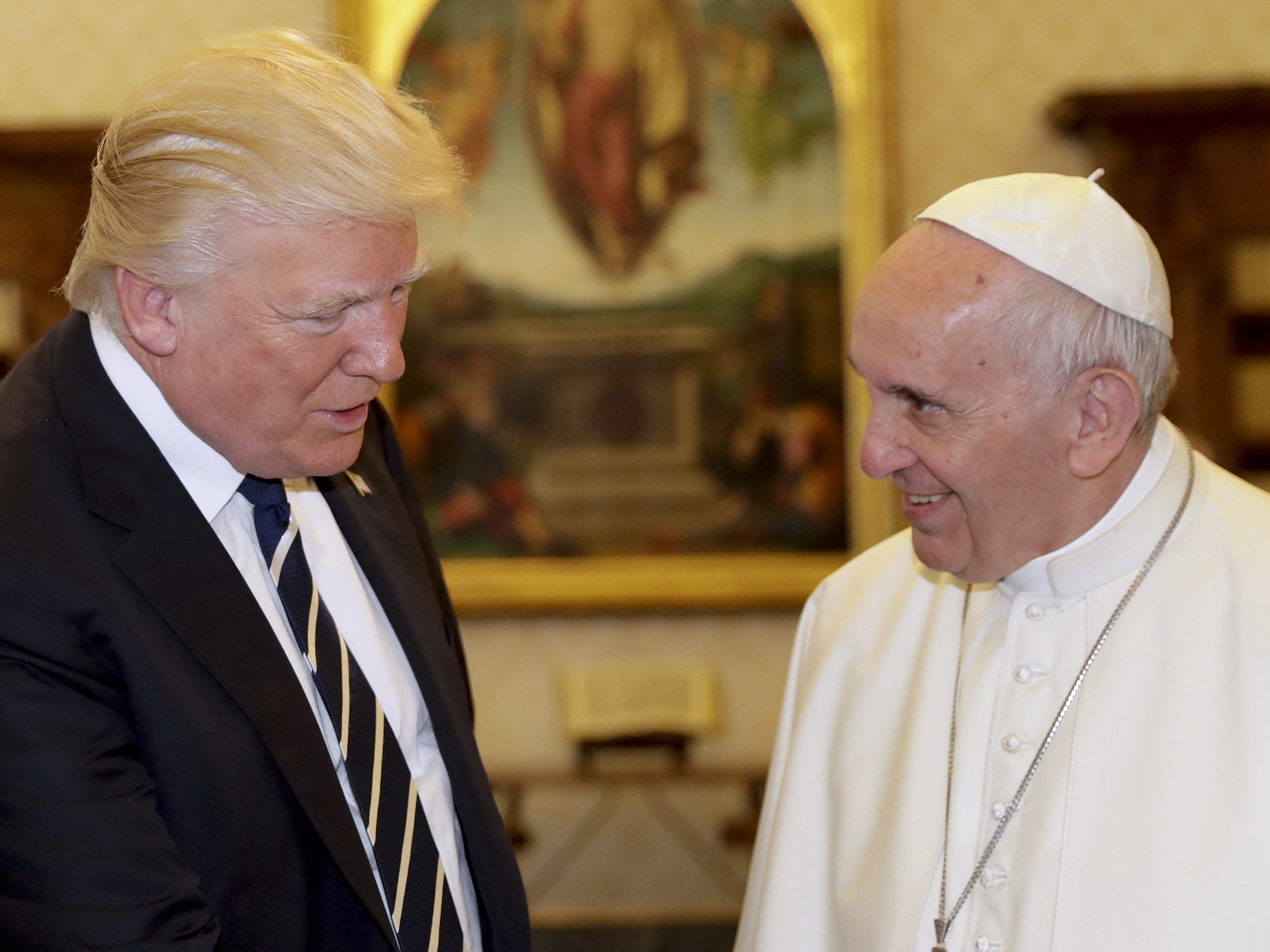 caption: President Trump is pictured at the Vatican in 2017 with Pope Francis, who died last month.  Trump posted on social media Friday what appears to be an AI-generated image of himself dressed as the pope.