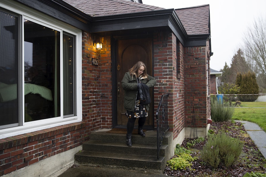 caption: Kara Peters leaves her home to walk to her bus stop on Wednesday, January 22, 2020, before commuting from Tacoma to Seattle for work.