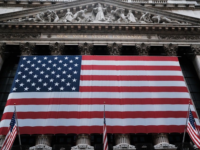 caption: Stocks fell again Monday as U.S. lawmakers continued to work on a massive stimulus measure. The floor of the New York Stock Exchange was closed as the exchange shifted to all-electronic trading amid the coronavirus outbreak.