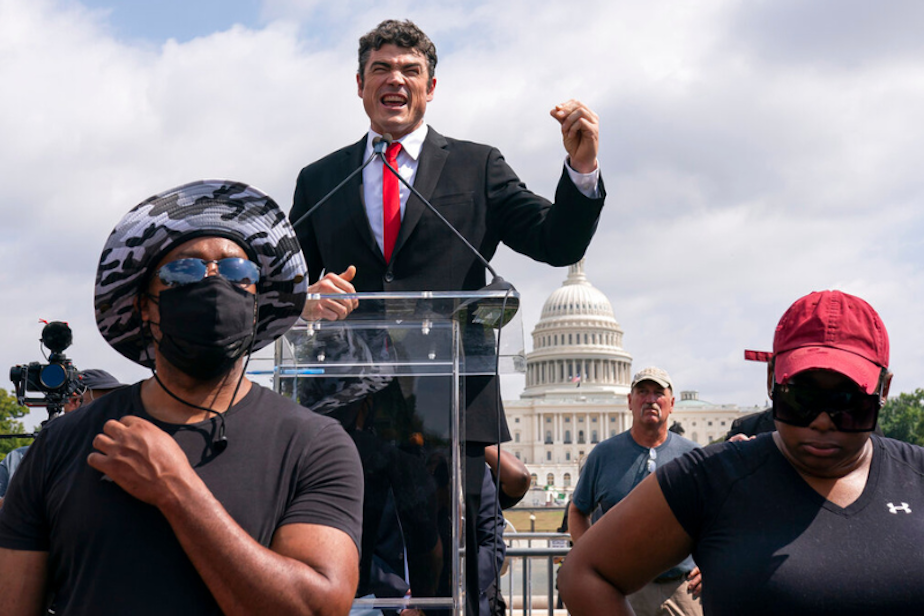 caption: MAGA Republican Joe Kent, center, speaks during a "Justice For J6" rally near the U.S. Capitol in Washington, on Sept. 18, 2021. 