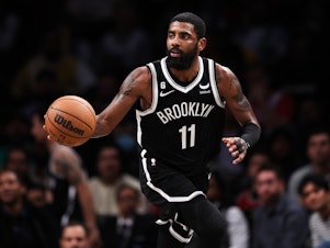 caption: Kyrie Irving is pictured during a game against the Chicago Bulls on Nov. 1 in New York City. Nike has terminated its contract with Irving.