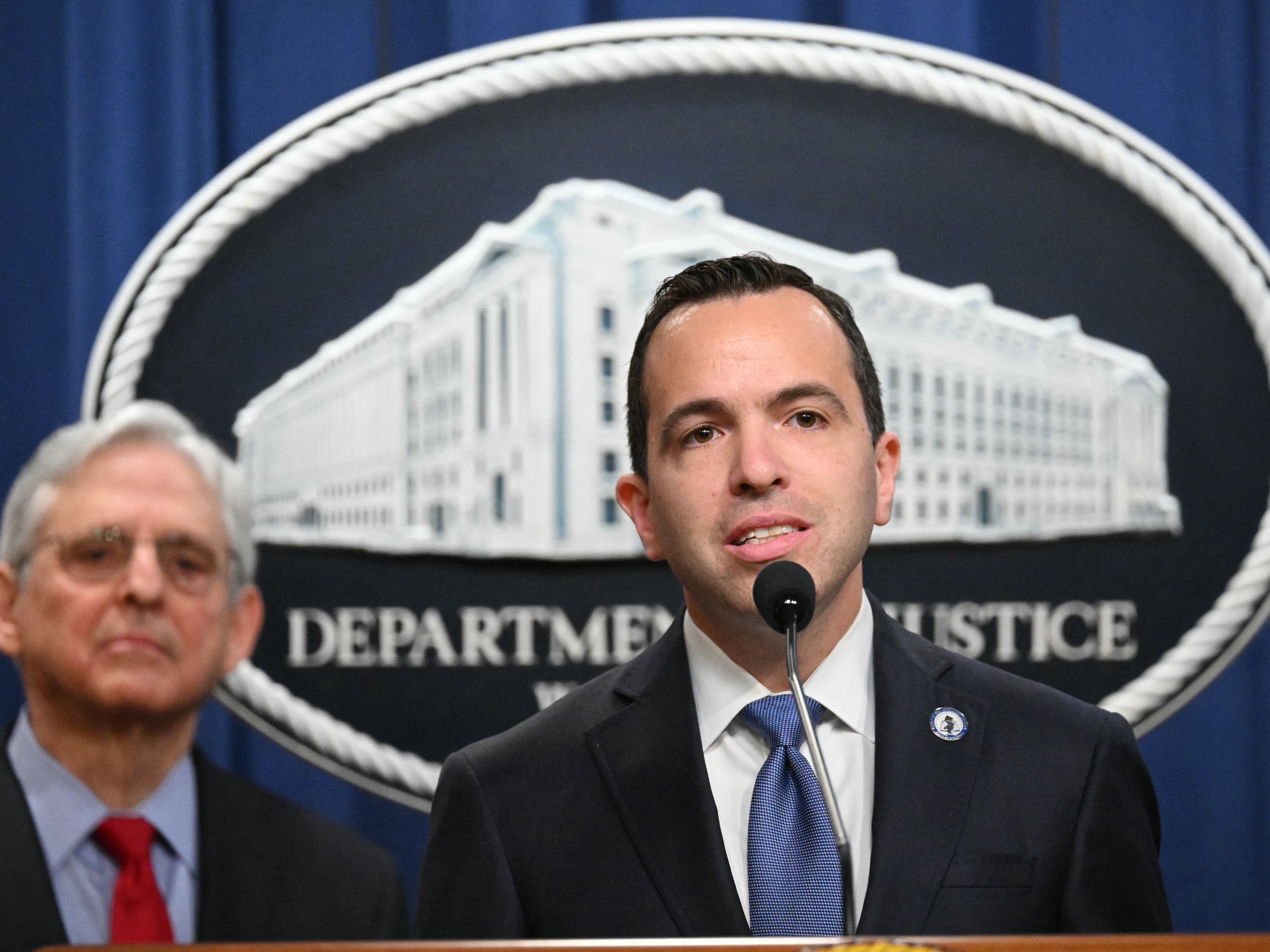 caption: New Jersey Attorney General Matthew Platkin (center) speaks during a press conference at the Justice Department in Washington, DC, on March 21, 2024.