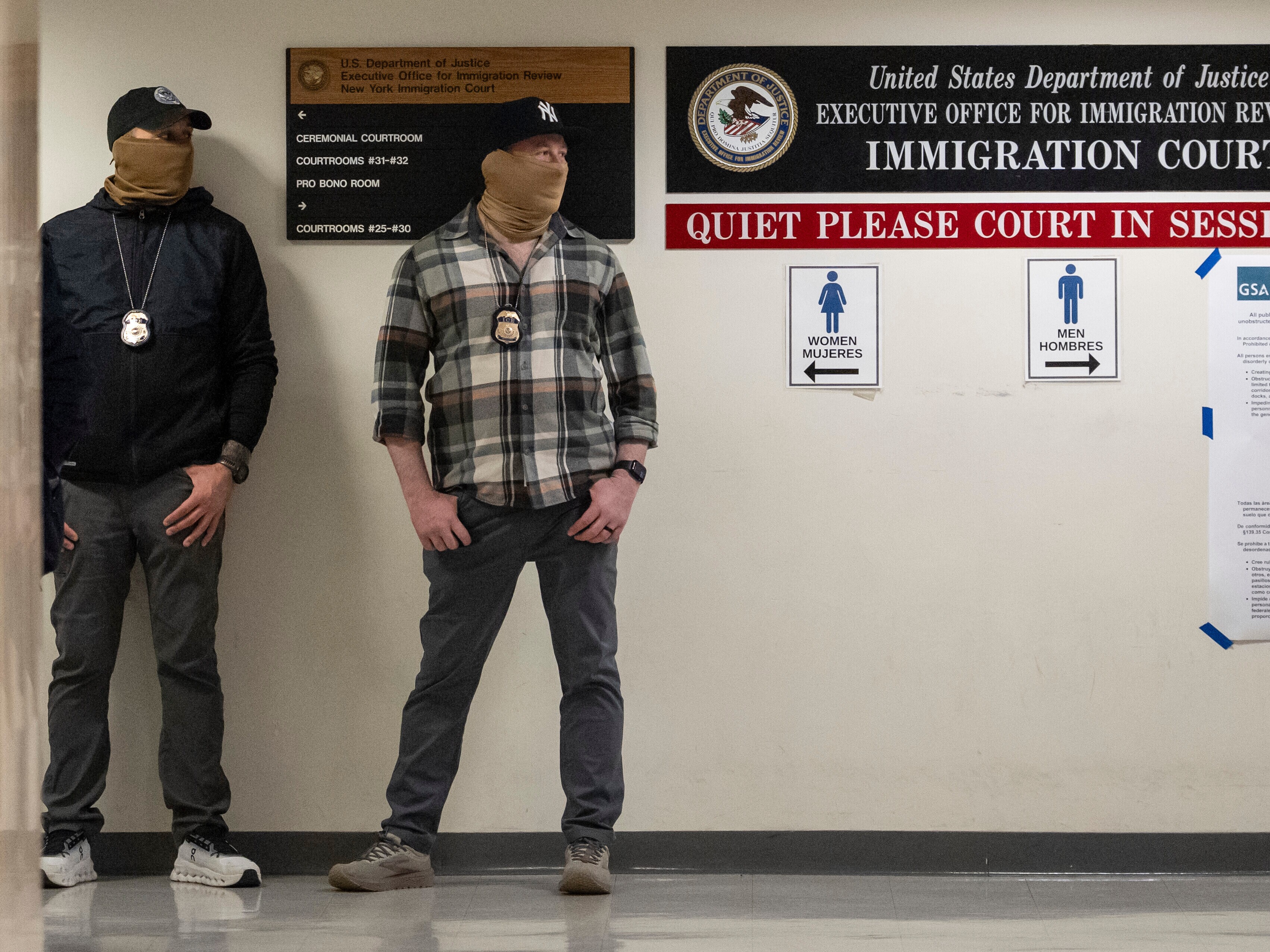 caption: Cases in immigration courts nationwide can be appealed to the Board of Immigration Appeals. Here, federal agents stand outside an immigration court in New York on March 6, 2026.