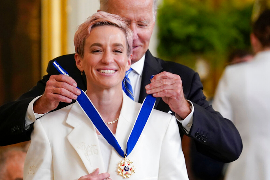 caption: President Joe Biden awards the nation's highest civilian honor, the Presidential Medal of Freedom, to Megan Rapinoe at the White House in Washington, Thursday, July 7, 2022. 
