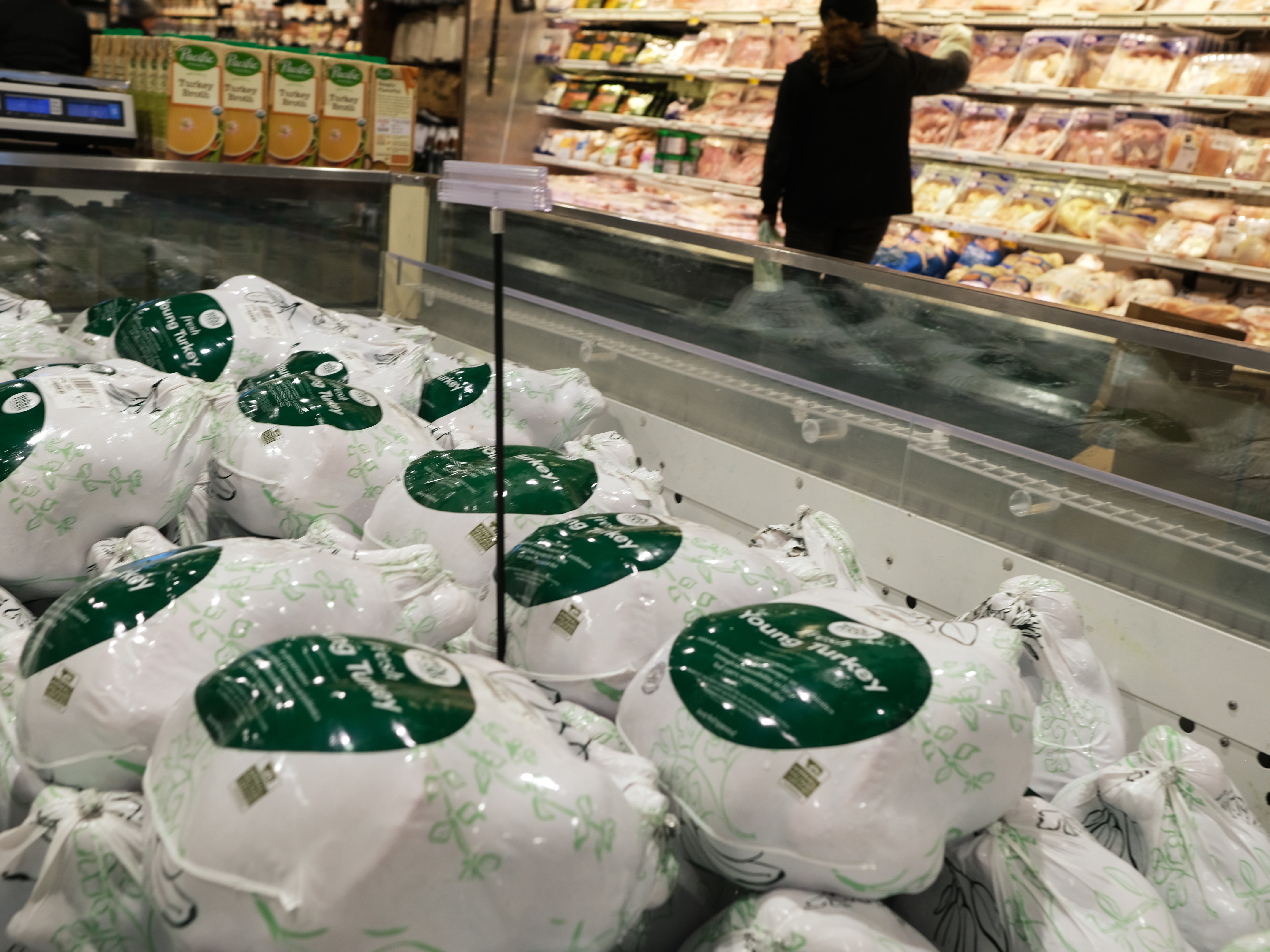 caption: Frozen turkeys are displayed for sale inside a grocery store on Nov. 14, 2022 in New York City.