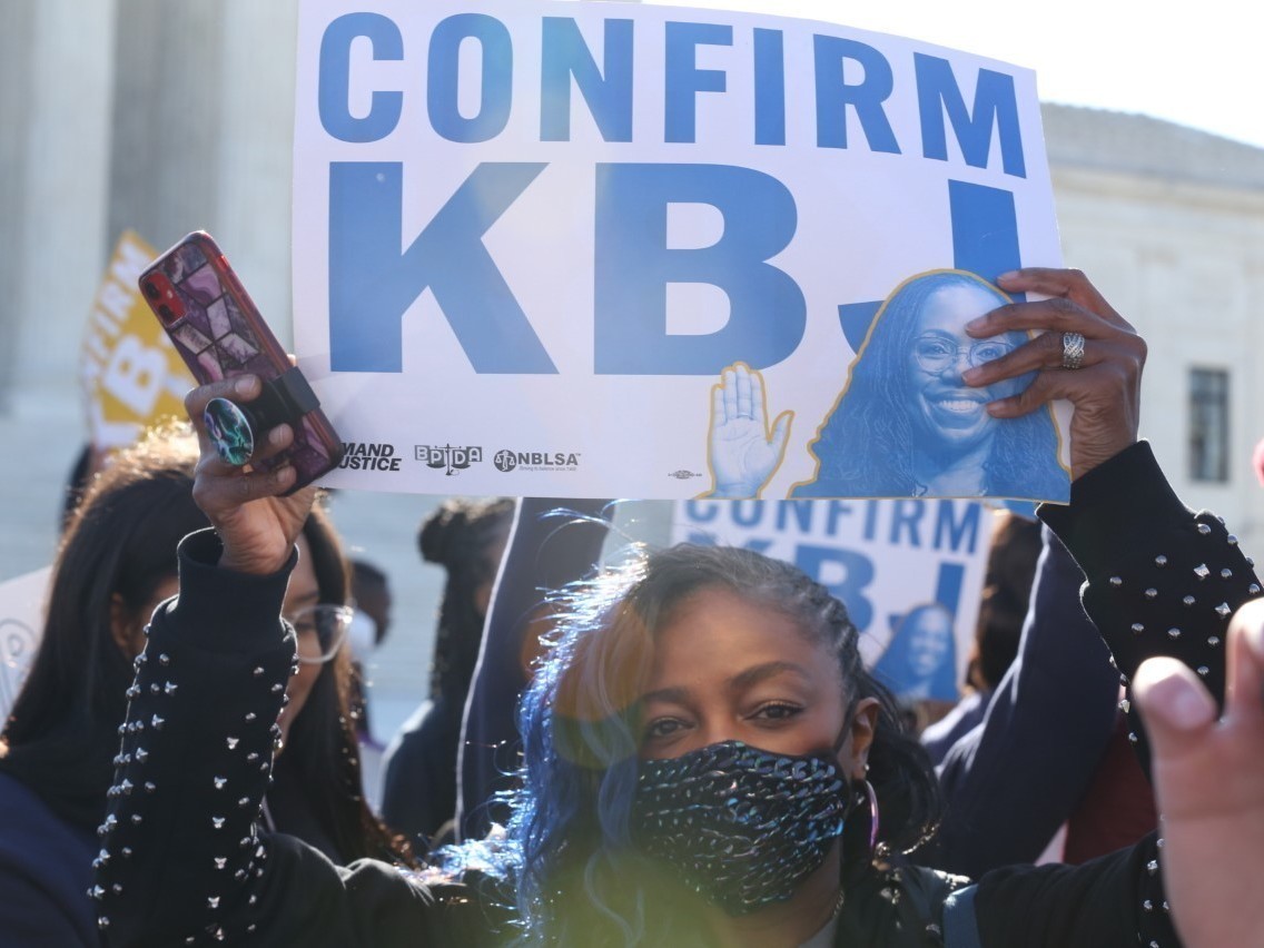 caption: A supporter of Judge Katanji Brown Jackson outside the Supereme Court.