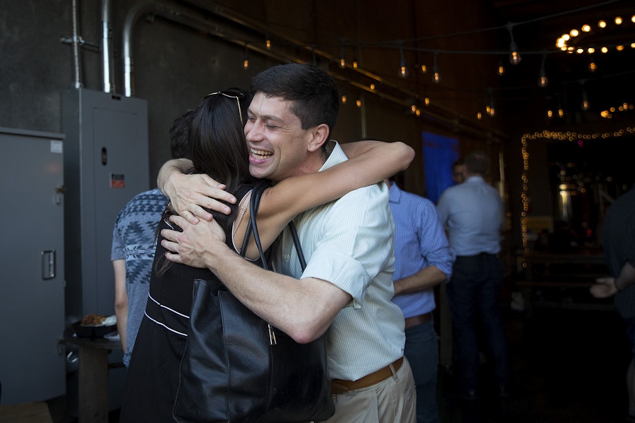 caption: Seattle City Councilmember Dan Strauss hugs friend and supporter Michelle Nance during a primary election night party on Tuesday, August 6, 2019, at Obec Brewing in Seattle. 