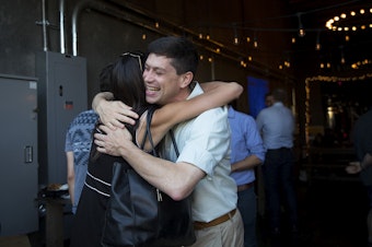 caption: Seattle City Councilmember Dan Strauss hugs friend and supporter Michelle Nance during a primary election night party on Tuesday, August 6, 2019, at Obec Brewing in Seattle. 