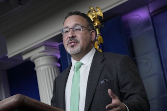 caption: U.S. Education Secretary Miguel Cardona speaks at a March briefing at the White House.