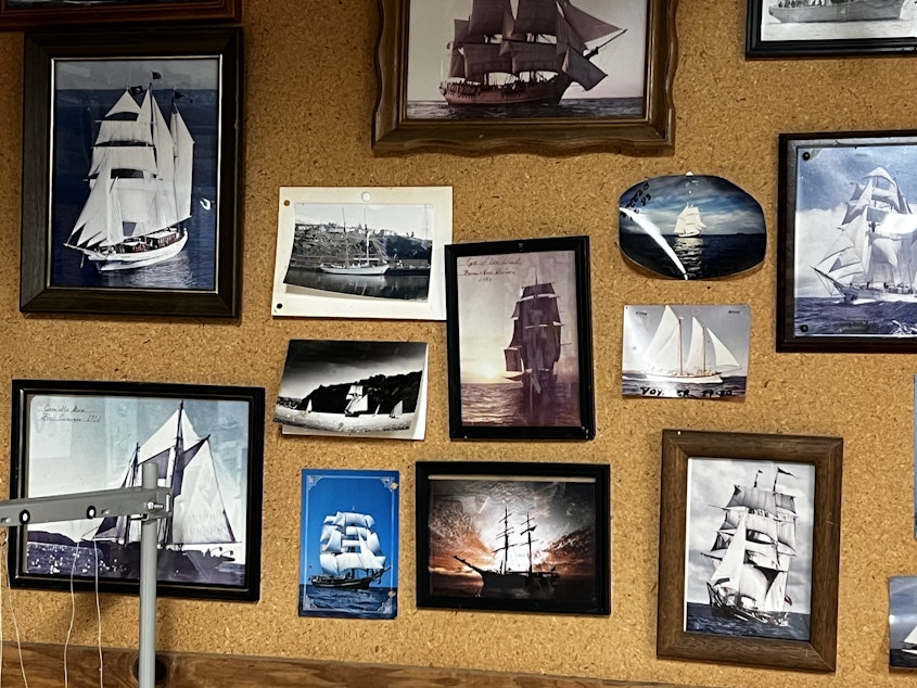 caption: A wall picturing the kinds of ships the Chimentis create sails for. The price of a single sail can range from $3,000 to $20,000.