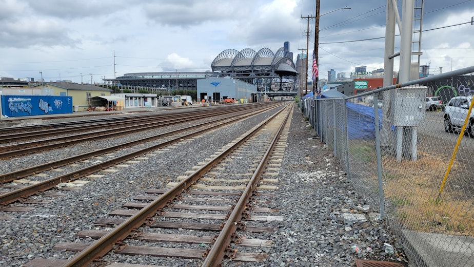 caption: The railroad crossing at Third Avenue and South Holgate Street, looking north toward T-Mobile Park.