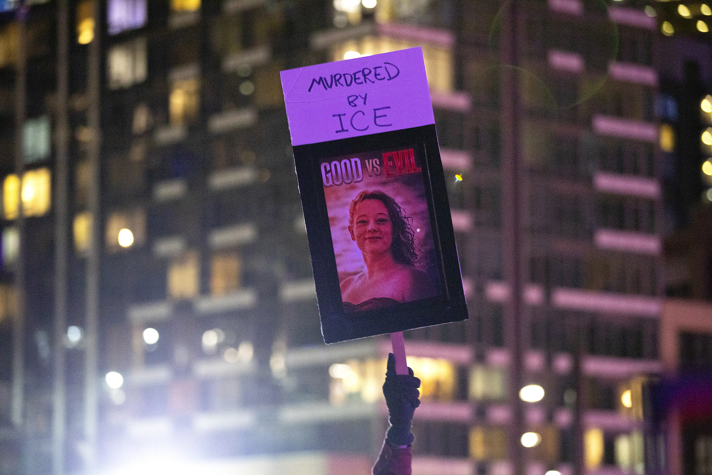 caption: A demonstrator holds a sign with Renee Nicole Good’s picture and the words ‘Murdered by ICE, Good vs. Evil,” during a vigil for the Minneapolis mom of three who was shot in the head and killed by ICE earlier this week, on Thursday, January 8, 2026, at Pier 58 in Seattle. 