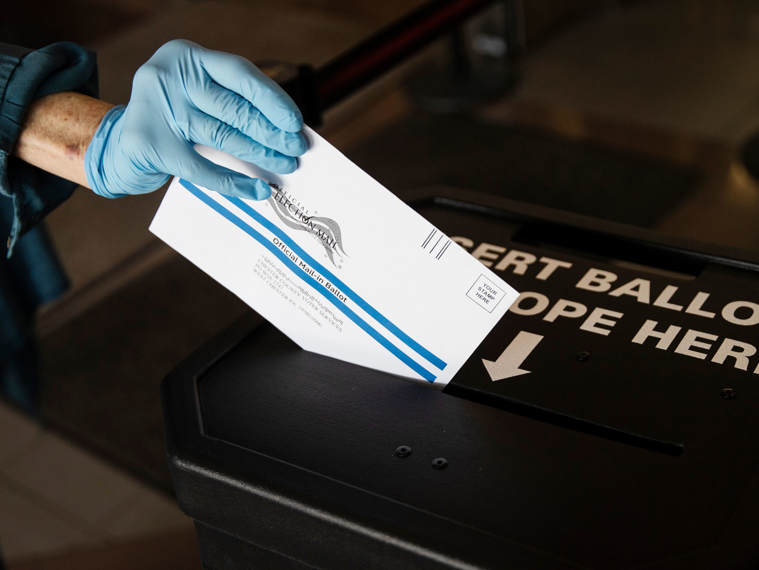 caption: A voter casts a mail-in ballot at in a drop box in West Chester, Pa., prior to the primary election. Statewide, Pennsylvania saw a nearly 18-fold increase in mail-in voting in the June 2 primary compared to 2016.