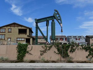 caption: Hundreds of active oil wells sit in densely populated and mostly low-income neighborhoods in Los Angeles. A new report details why equity should be central to climate and energy policy in the U.S. to address historical practices.
