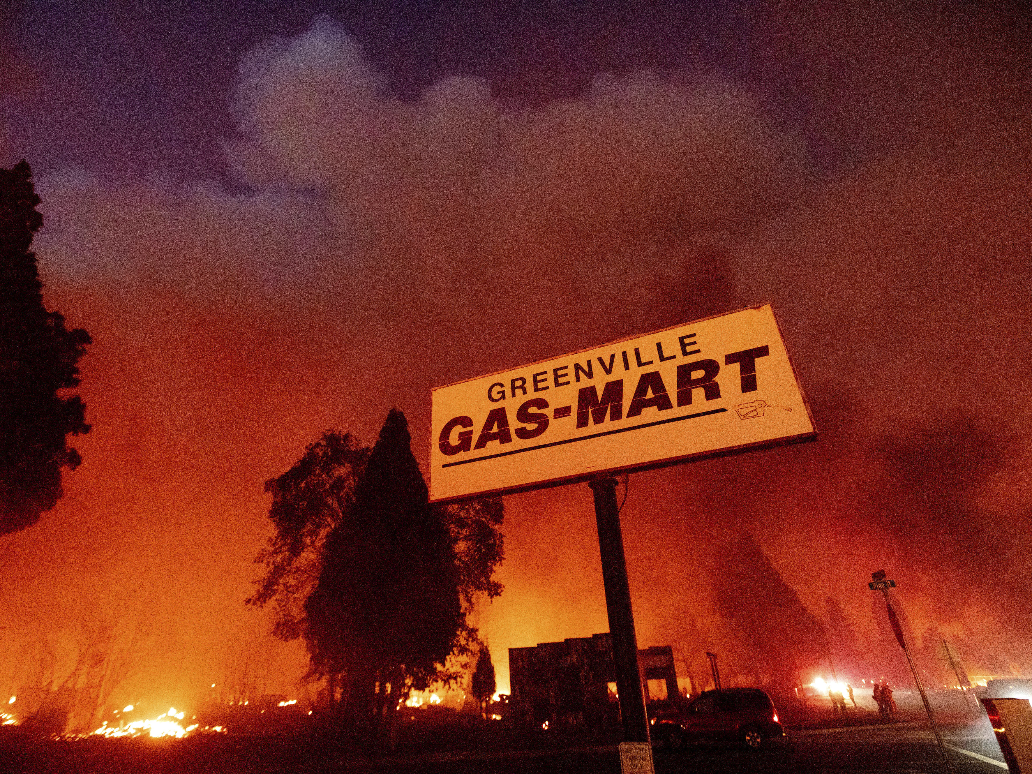 caption: Flames consume buildings as the Dixie Fire tears through the Greenville community of Plumas County, Calif., on Aug. 4, 2021.