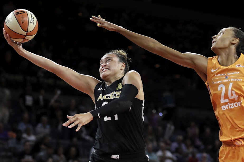 caption: Las Vegas Aces guard Kayla McBride shoots around Phoenix Mercury forward DeWanna Bonner during the second half of a WNBA basketball game Wednesday, Aug. 1, 2018, in Las Vegas. The Aces refused to play a game in August 2018 citing injury risks, something no women's team had ever done. (John Locher/AP)