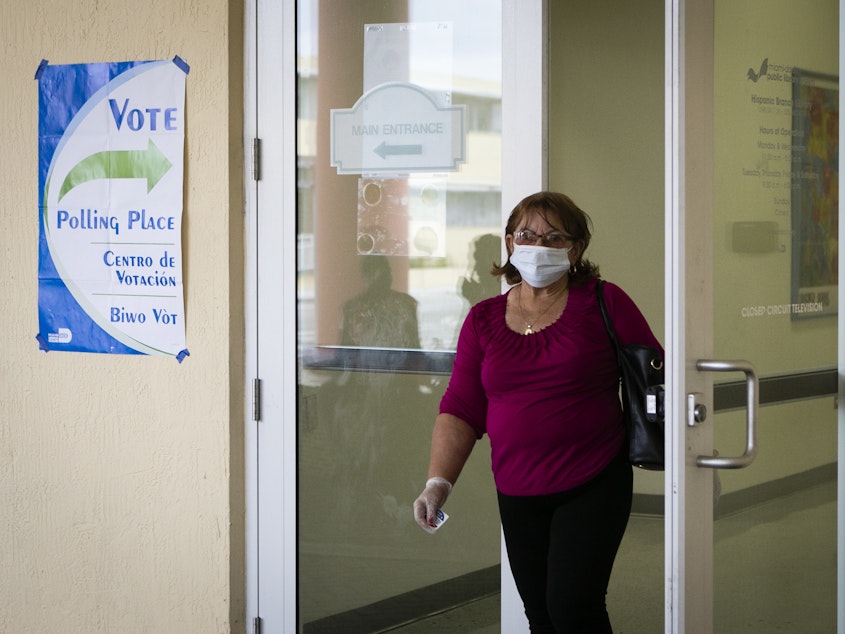 caption: A woman wearing mask and protective gloves leaves after cast her vote during the Florida Democratic primary election in Miami, Florida, on March 17, 2020. The latest Senate coronavirus relief bill includes $400 million to states to ensure upcoming elections are safe for voters and pollworkers.