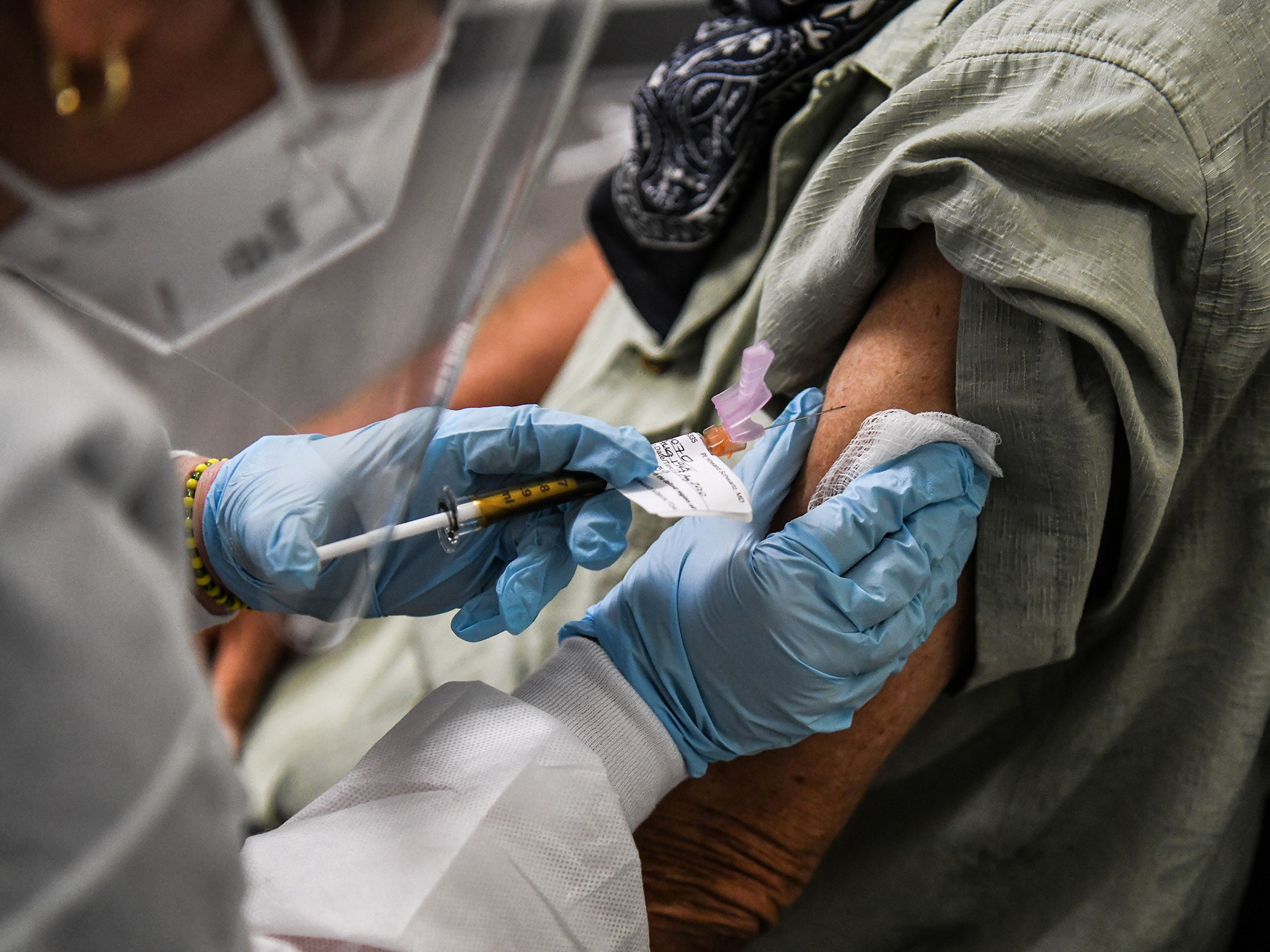 caption: Several COVID-19 vaccines are being studied in trials around the country. Once the Food and Drug Administration authorizes a vaccine for use, health leaders must decide which groups of people get to receive the vaccine first.