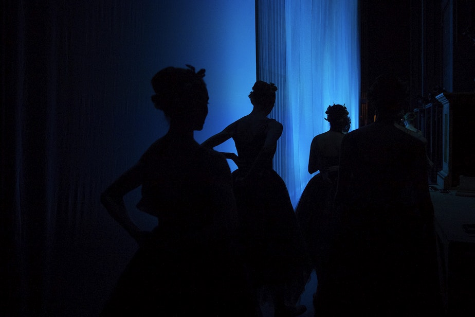 caption: Dancers make their way backstage to change costumes in between acts during the Pacific Northwest Ballet's performance of Cinderella on Saturday, February 1, 2020, at McCaw Hall in Seattle.