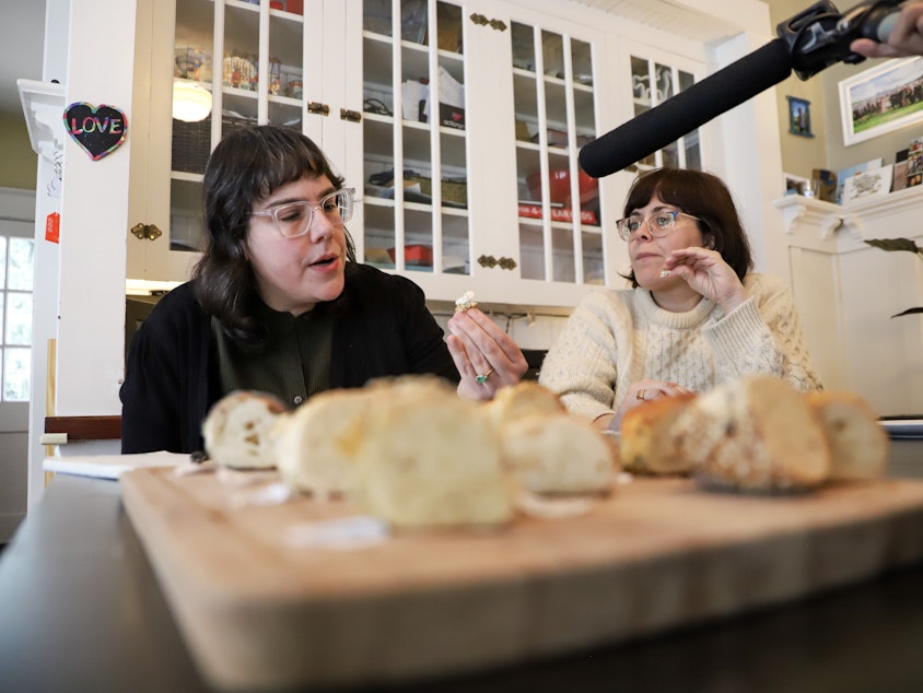 caption: Friends Carrine Fisher and Isolde Raftery have a conversation about bagels while trying 13 pieces of bagels during Bagel Quest on Feb.17, 2024.
