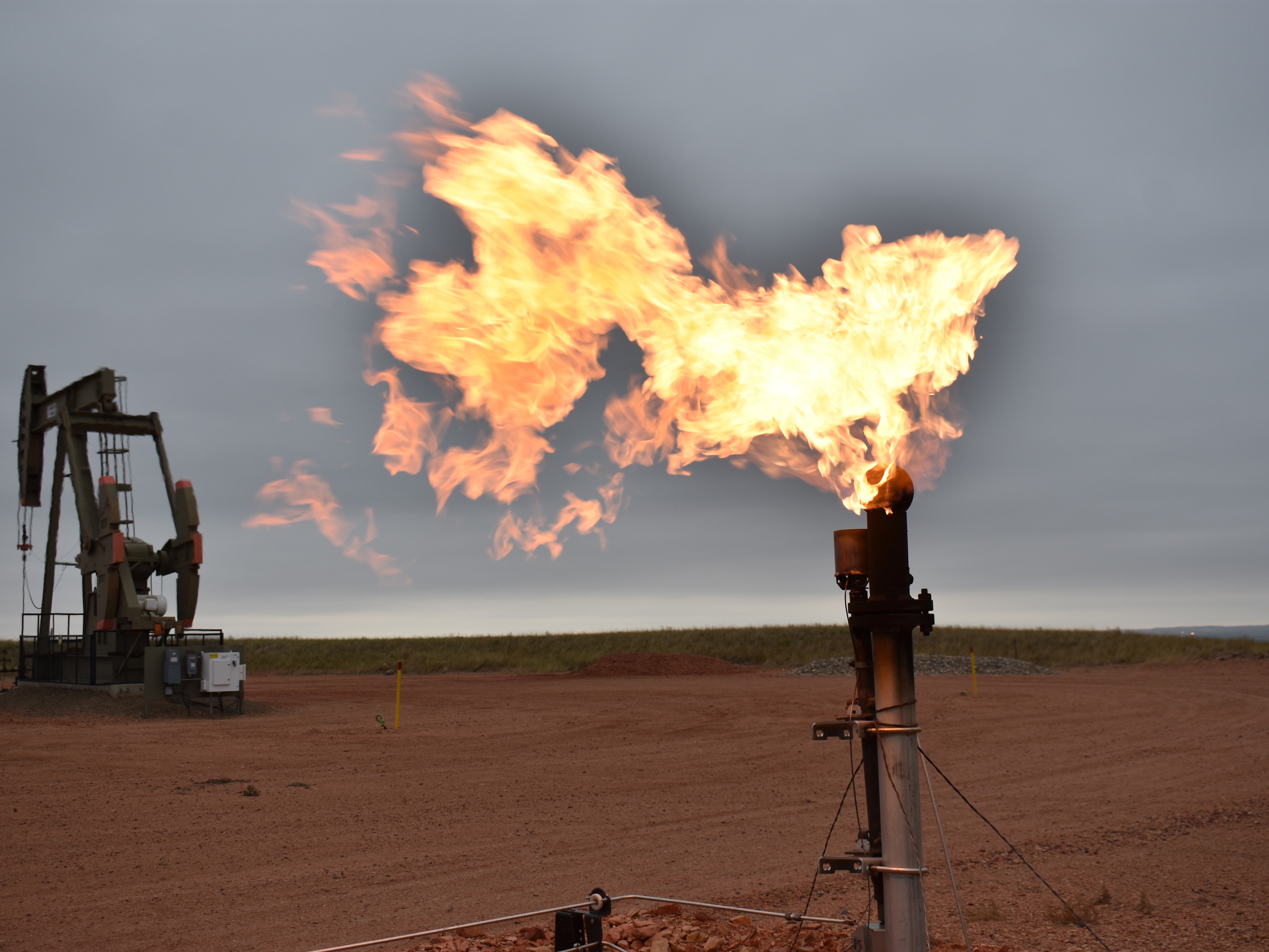 caption: A flare burns natural gas at an oil well in Watford City, N.D. in 2021. Oil and natural gas companies would have to pay a fee for methane emissions that exceed certain levels under a new rule announced by the Environmental Protection Agency Tuesday.
