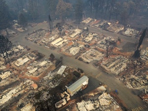 caption: An aerial view of a neighborhood destroyed by the Camp Fire in Paradise, Calif. Fueled by high winds and low humidity, the wildfire ripped through the town, charring more than 140,000 acres and killing more than 60 people.
