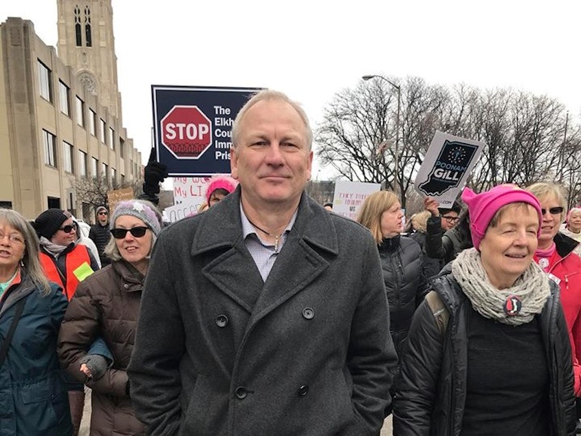 caption: Steve Schoettmer marches with protesters at the Women's March in Indianapolis. He decided to run for Indiana House District 69 after his girlfriend, Rose Sachiko Callahan, died of colon cancer in 2017.