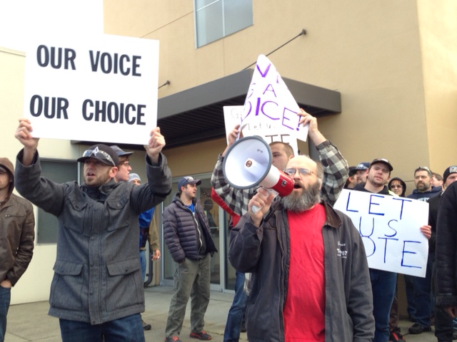 caption: Union members marched yesterday in support of taking a vote on the latest Boeing contract offer.