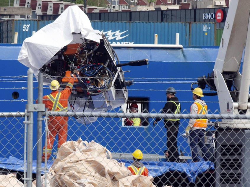 caption: Debris from the Titan submersible, recovered from the ocean floor near the wreck of the Titanic, is unloaded from the ship Horizon Arctic at the Canadian Coast Guard pier in St. John's, Newfoundland, Wednesday, June 28, 2023.