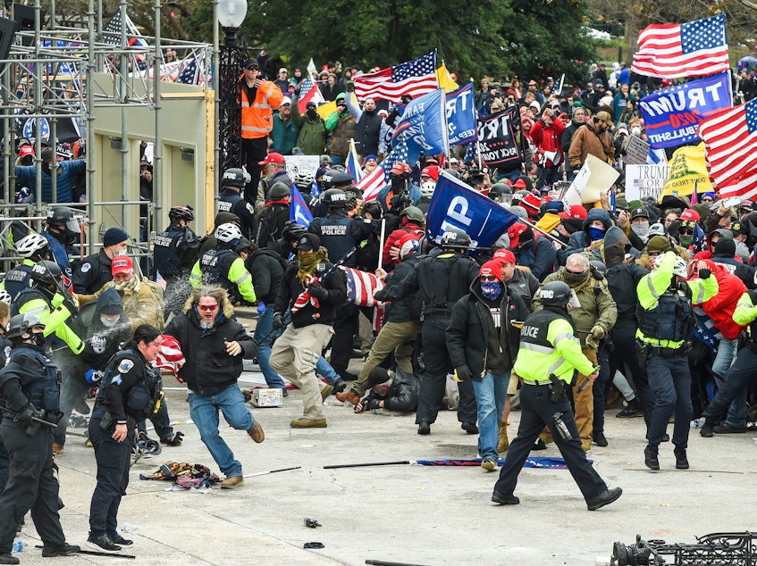 caption: Trump supporters clash with police and security forces as they storm the U.S. Capitol on Jan. 6.