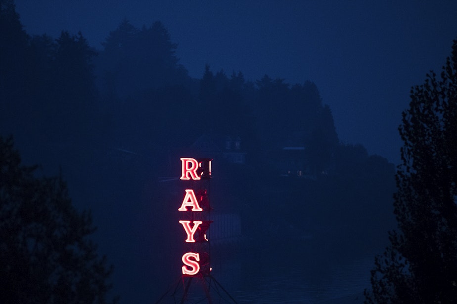 caption: A sign at Ray's Boathouse lights up on Friday, September 11, 2020, as smoke from wildfires burning in Oregon and California clouds the air, in Seattle.