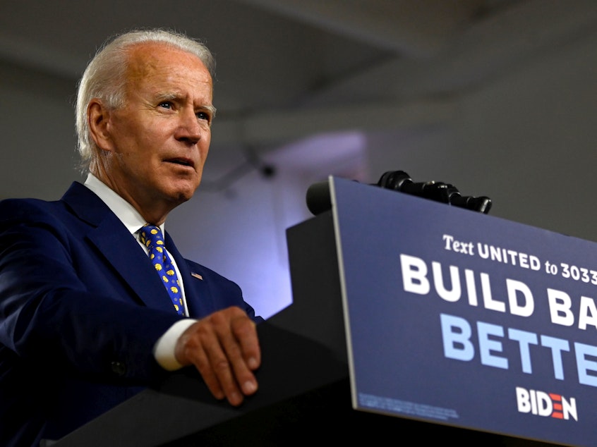 caption: Presumptive Democratic nominee Joe Biden, seen here at a campaign event in July, says he won't tear down the border wall put in place during the Trump administration.