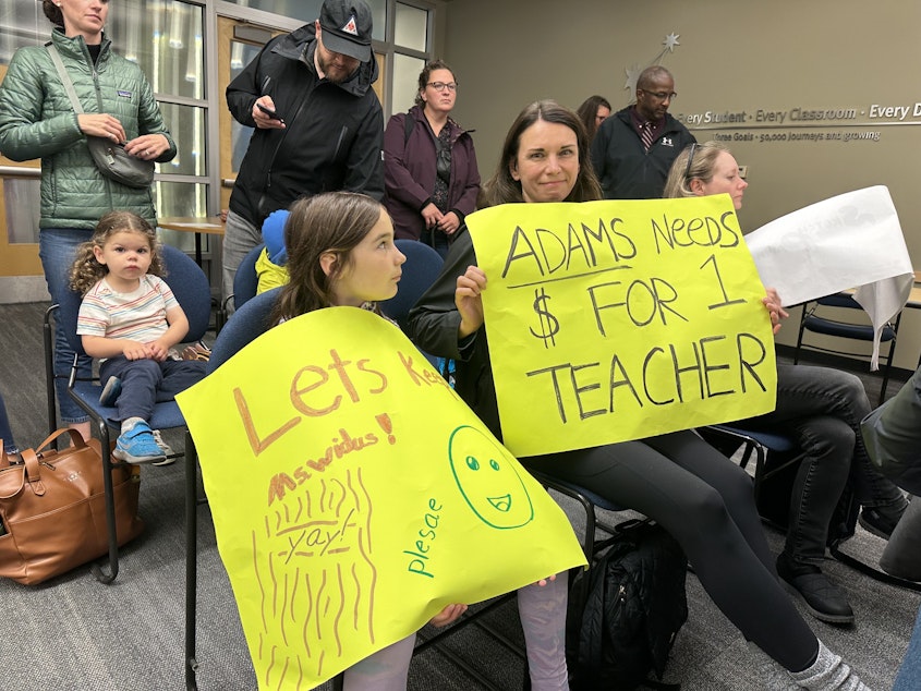caption: An Adams Elementary mom and her daughter were among those who crowded the Seattle School Board meeting to speak out against widespread class size adjustments.