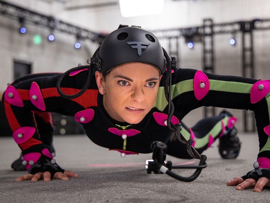 caption: Actor and stunt performer Andi Norris wears a full body suit covered in sensors — part of the behind-the-scenes process that makes video game characters come to life. Norris is part of the negotiating team for SAG-AFTRA, which is on strike against major gaming companies. The future of AI in game development has become a central issue. 