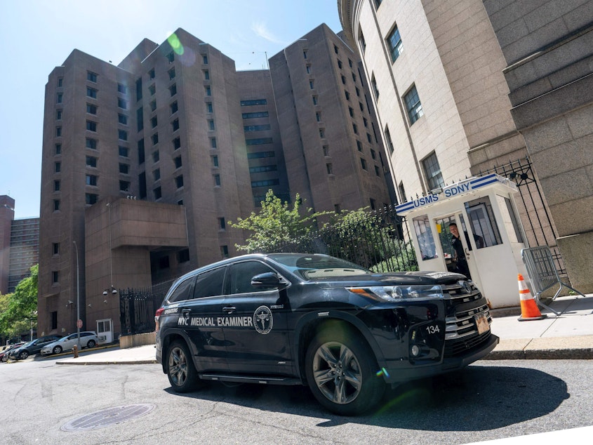 caption: A New York Medical Examiner's car is parked outside the Metropolitan Correctional Center where financier Jeffrey Epstein was being held in New York. Epstein committed suicide in prison while awaiting trial.