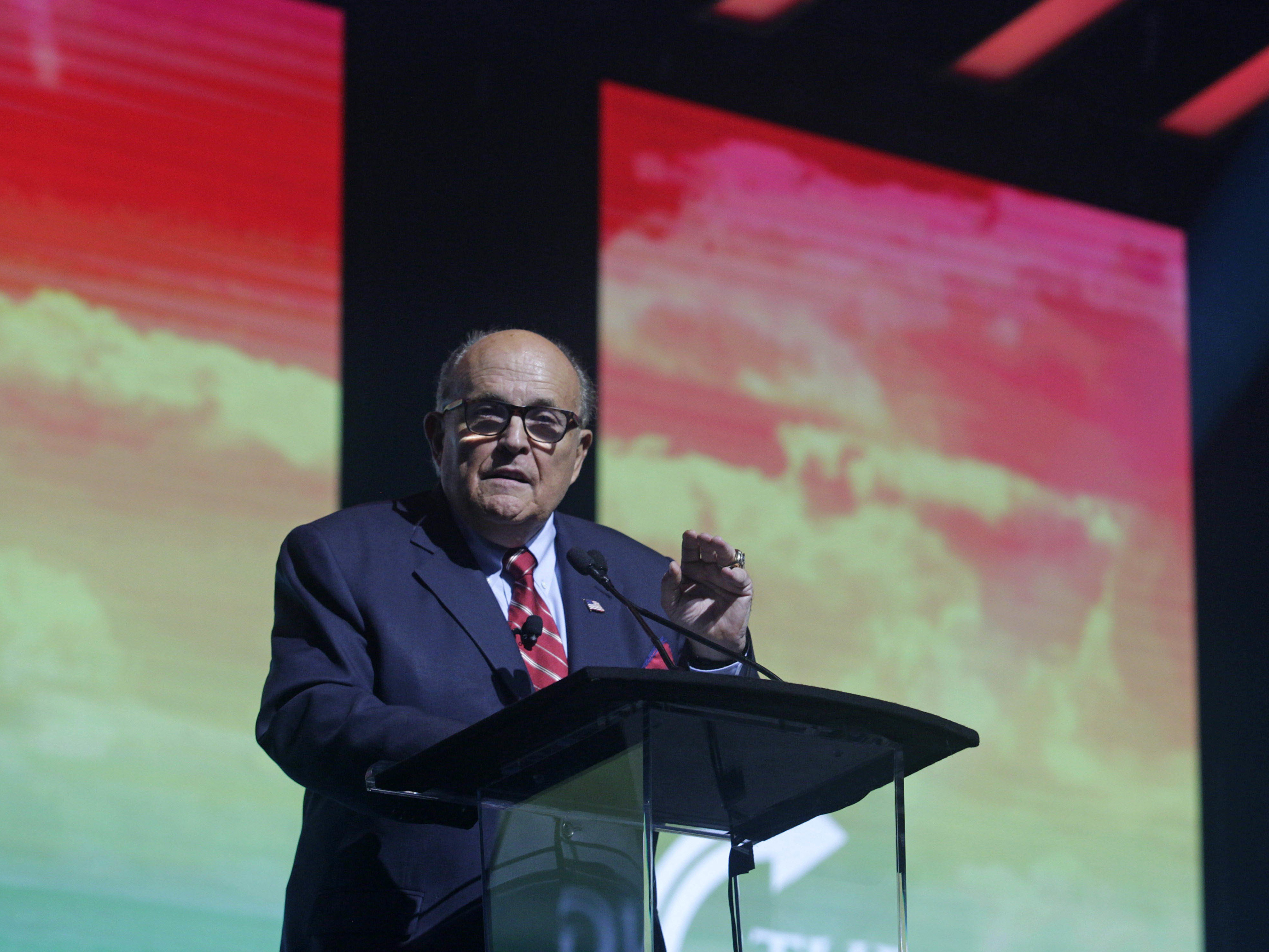 caption: Rudy Giuliani addresses the crowd at the Turning Point USA Student Action Summit on Dec. 19, 2019 in Palm Beach, Fla.