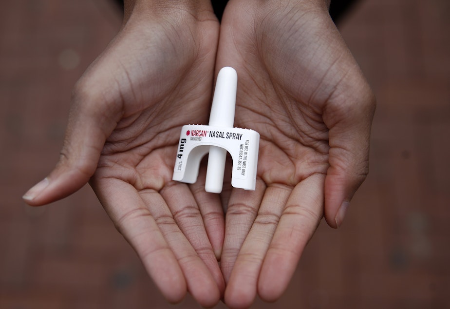 In this Jan. 23, 2018 photo, Leah Hill, a behavioral health fellow with the Baltimore City Health Department, displays a sample of Narcan nasal spray in Baltimore. Public health officials say the drug is a critical tool in addressing America's opioid epidemic. (AP Photo/Patrick Semansky)
