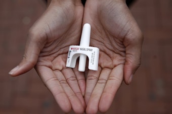 In this Jan. 23, 2018 photo, Leah Hill, a behavioral health fellow with the Baltimore City Health Department, displays a sample of Narcan nasal spray in Baltimore. Public health officials say the drug is a critical tool in addressing America's opioid epidemic. (AP Photo/Patrick Semansky)