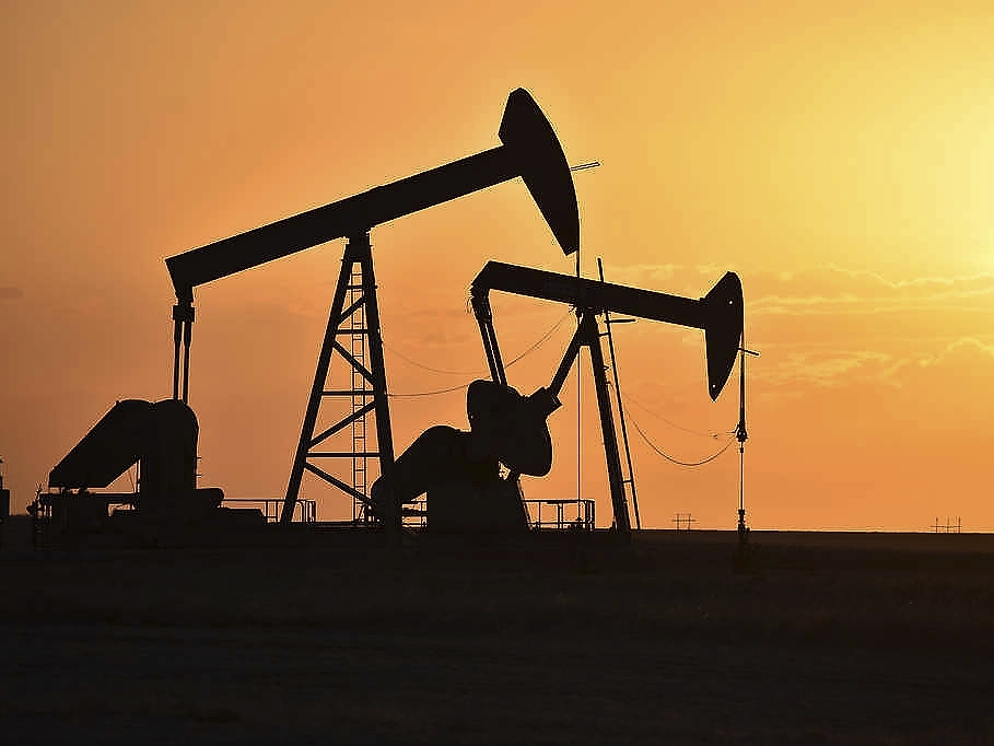 caption: Pump jacks extract oil from beneath the ground in North Dakota on May 19, 2021. The federal government announced a $241.5 million settlement with Marathon Oil on Thursday for alleged air quality violations at the company's oil and gas operations in the Forth Berthold Indian Reservation in North Dakota. 