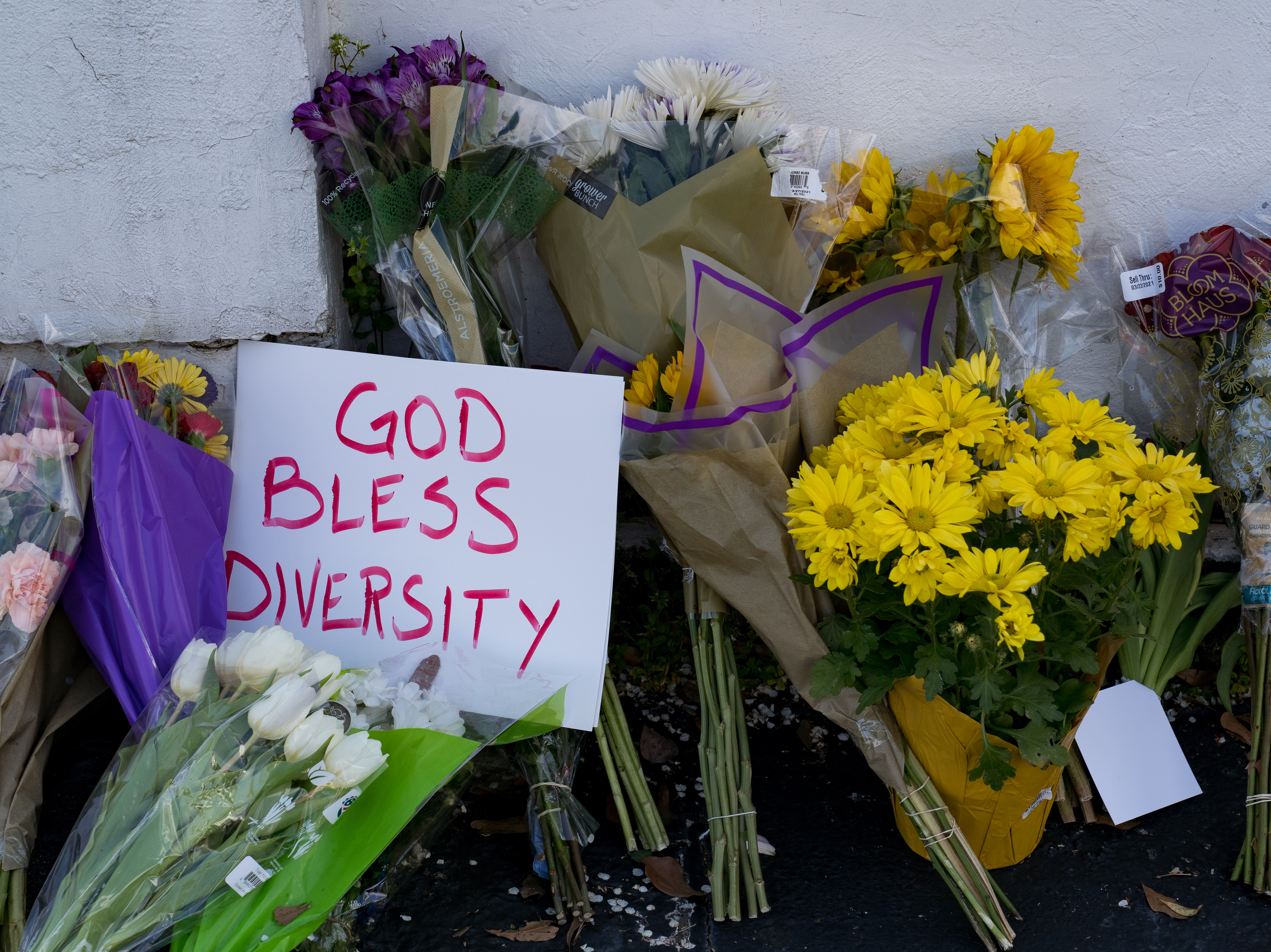 caption: Flowers and signs adorn Gold Spa in Atlanta during a demonstration on Thursday opposing violence against women and Asians following this week's deadly shootings in the area.