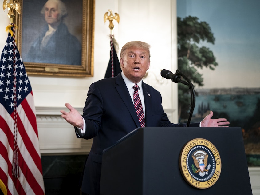 caption: President Trump defended downplaying the coronavirus as necessary to keep the nation calm after excerpts were released from Bob Woodward's new book, <em>Rage</em>.