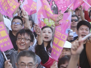 caption: Supporters of President Tsai cheer at her reelection campaign launch in November.