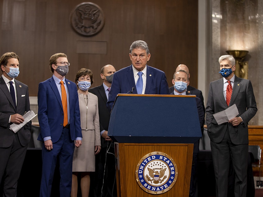 caption: West Virginia Sen. Joe Manchin, who's seen here alongside a group of Democratic and Republican members of Congress as they announce a proposal for a COVID-19 relief bill on Dec. 1, said Sunday that negotiations on the bill's text are ongoing.