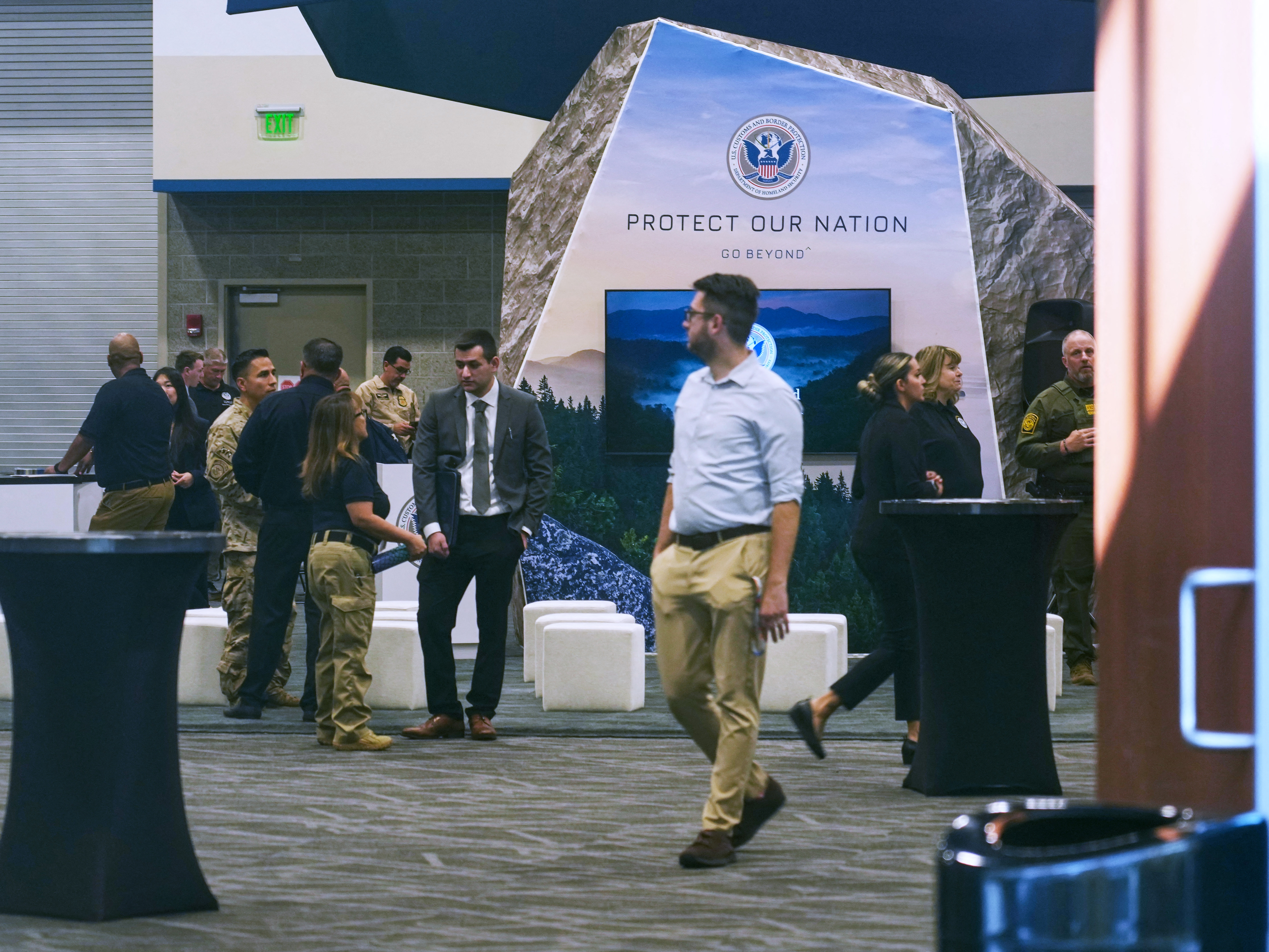 caption: People arrive at an ICE recruitment job fair at the Utah Valley Convention Center in Provo, Utah, on Sept. 15.
