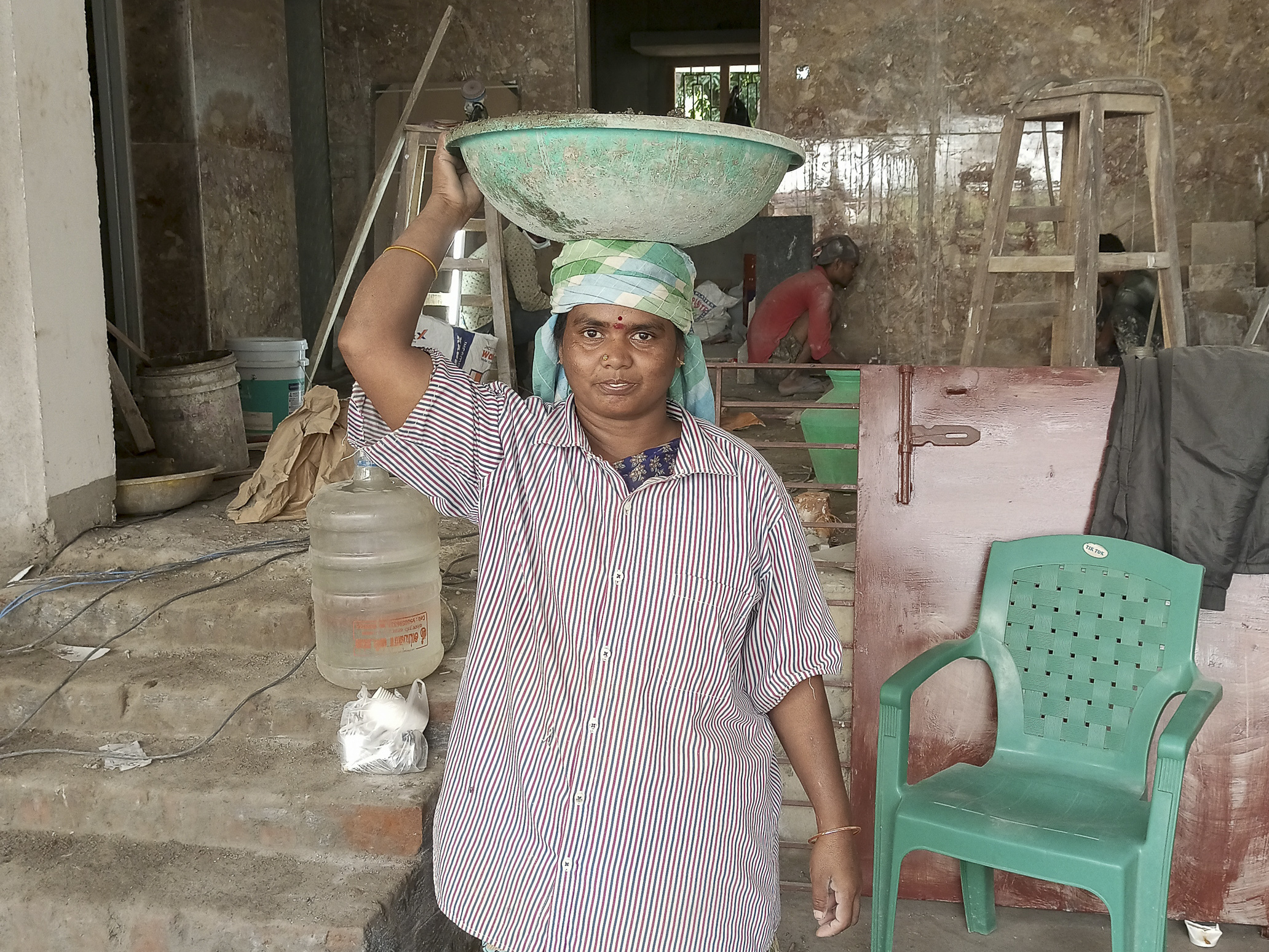 caption: Selvi is a construction worker in Chennai, India. "My bones ache at night after carrying heavy loads through the day, my eyes sting from the dust and I cough often, but if I didn't do this, my kids and I would starve." she says.