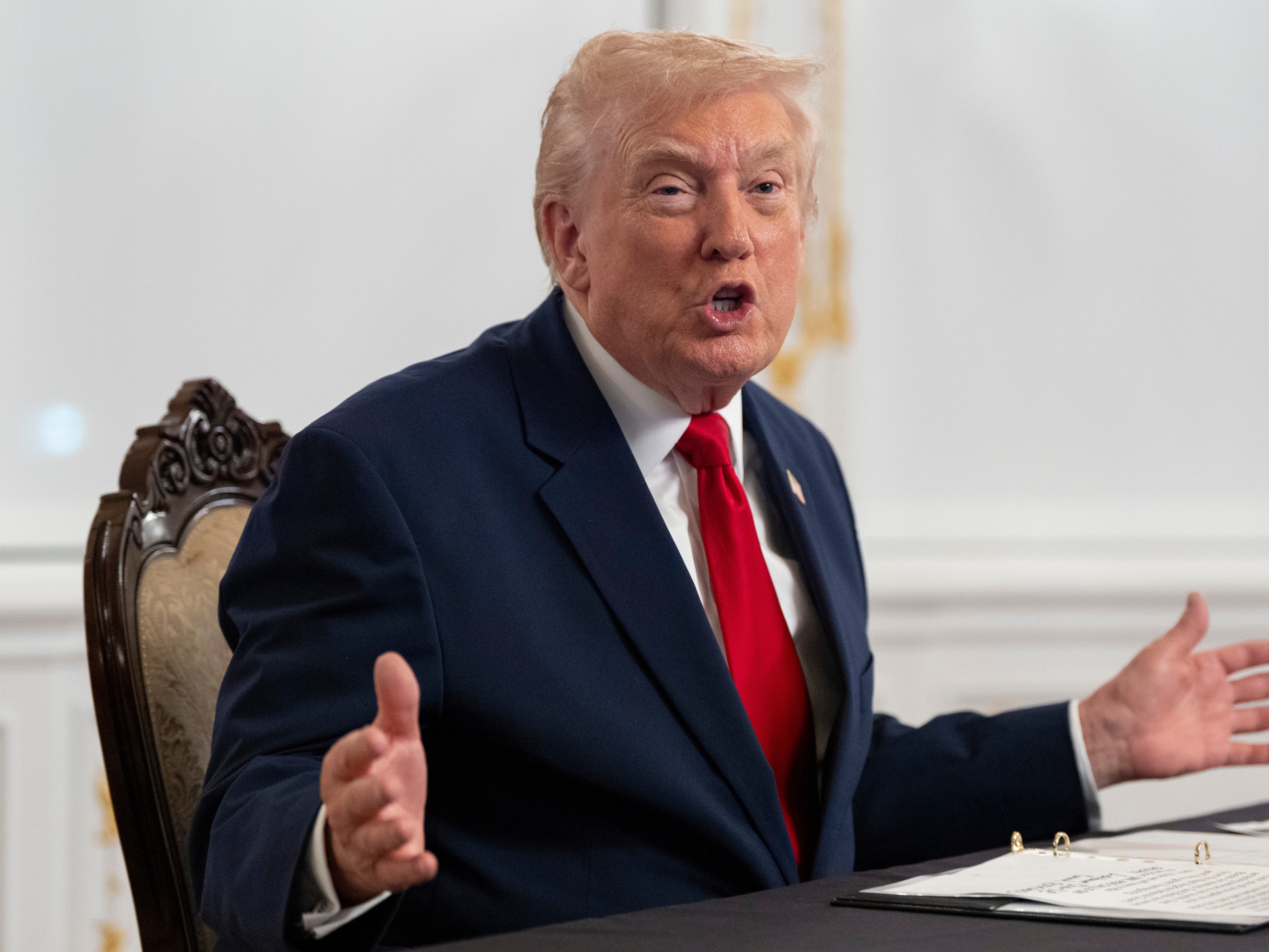 caption: President Donald Trump speaks to reporters after speaking to troops via video from his Mar-a-Lago estate on Thanksgiving, Thursday, Nov. 27, 2025, in Palm Beach, Fla.