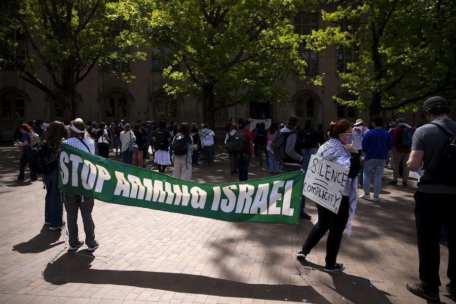 caption: ‘Stop Arming Israel’ reads a banner as a crowd gathers on Thursday, May 8, 2025, in front of Gerberding Hall on the University of Washington campus in Seattle.